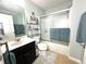 Bathroom featuring a glass door shower/tub, vanity, toilet, and storage shelves at 16334 Saint Augustine St, Clermont, FL 34714
