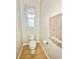 Clean half bathroom features a toilet, neutral tile, and a towel rack at 16334 Saint Augustine St, Clermont, FL 34714