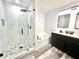 Modern bathroom featuring a walk-in shower, soaking tub, dual sink vanity, and updated fixtures at 16334 Saint Augustine St, Clermont, FL 34714