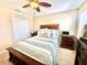 Inviting bedroom with carpet flooring, a ceiling fan, and a dresser at 16334 Saint Augustine St, Clermont, FL 34714