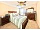 Cozy bedroom with a ceiling fan, a window, and a dresser with decorative accents at 16334 Saint Augustine St, Clermont, FL 34714