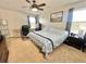 Comfortable bedroom with a ceiling fan, carpet flooring, and abundant natural light at 16334 Saint Augustine St, Clermont, FL 34714