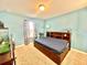 Bedroom boasts a paneled bed frame with drawers, neutral carpet, and a window with curtains at 16334 Saint Augustine St, Clermont, FL 34714