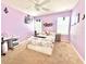 Cozy bedroom features a ceiling fan, lilac walls, and natural light from two windows at 16334 Saint Augustine St, Clermont, FL 34714