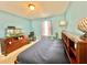 Bedroom featuring a paneled bed frame with drawers, neutral carpet, and a blue wall paint at 16334 Saint Augustine St, Clermont, FL 34714