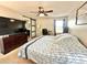 Primary bedroom features a ceiling fan, a dresser, and an attached bathroom with modern finishes at 16334 Saint Augustine St, Clermont, FL 34714