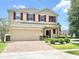 Charming two-story home with a brick-paved driveway and well-manicured lawn at 16334 Saint Augustine St, Clermont, FL 34714