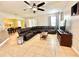Spacious living room with neutral tile flooring and ample seating with a leather sectional sofa at 16334 Saint Augustine St, Clermont, FL 34714