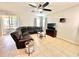 Spacious living room with neutral tile flooring and ample seating with a leather sectional sofa at 16334 Saint Augustine St, Clermont, FL 34714