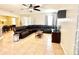 Spacious living room with neutral tile flooring and ample seating with a leather sectional sofa at 16334 Saint Augustine St, Clermont, FL 34714
