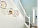 Close-up of the staircase with hexagonal shelves and white railing at 16334 Saint Augustine St, Clermont, FL 34714