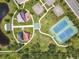 Aerial view of community park offering tennis courts, basketball courts, playgrounds, and walking trails around a pond at 16724 Cedar Crest Dr, Orlando, FL 32828