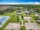 Community park aerial with playgrounds, tennis and basketball courts, green space, walking paths, and pond with fountain at 16724 Cedar Crest Dr, Orlando, FL 32828