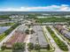Wide aerial view of a residential area featuring townhouses and lakes surrounded by green trees at 16724 Cedar Crest Dr, Orlando, FL 32828