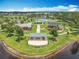 Aerial view of community park with tennis courts, playground, picnic pavilions and green space by the lake at 16724 Cedar Crest Dr, Orlando, FL 32828