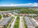Aerial view of a residential neighborhood with townhouses and a pond in a wooded area at 16724 Cedar Crest Dr, Orlando, FL 32828