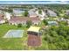Aerial view of a community playground adjacent to townhomes, a pool, and a lake at 16724 Cedar Crest Dr, Orlando, FL 32828
