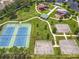 This aerial view shows the community park that includes tennis and basketball courts along with two playgrounds and water feature at 16724 Cedar Crest Dr, Orlando, FL 32828