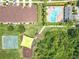 Overhead view showcases a community pool, playground, and a tennis court surrounded by townhomes at 16724 Cedar Crest Dr, Orlando, FL 32828