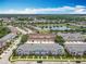 Picturesque aerial view showcasing a community with a central pond and lush landscaping at 16724 Cedar Crest Dr, Orlando, FL 32828