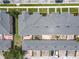 A bird's eye shot displays the roofs, brick patios, and parking for the townhouse complex at 16724 Cedar Crest Dr, Orlando, FL 32828