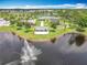 Aerial view showcases park amenities, offering tennis courts, playgrounds, a pavilion, and a scenic lake with fountain at 16724 Cedar Crest Dr, Orlando, FL 32828
