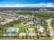 Aerial view of neighborhood park including playgrounds, tennis and basketball courts, walking trails, and a serene pond at 16724 Cedar Crest Dr, Orlando, FL 32828