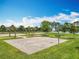Community outdoor basketball court surrounded by trees, landscaping, and walking trails at 16724 Cedar Crest Dr, Orlando, FL 32828