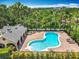 An aerial view of a community pool with sun loungers surrounded by tropical landscaping at 16724 Cedar Crest Dr, Orlando, FL 32828
