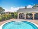 Community spa with easy stair access under shaded patio, surrounded by trees and plantings at 16724 Cedar Crest Dr, Orlando, FL 32828