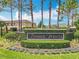 The Timber Pointe community sign featuring lush landscaping and towering palm trees at 16724 Cedar Crest Dr, Orlando, FL 32828