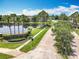 A landscaped entrance sign next to pond with palm trees, marking the community at 16724 Cedar Crest Dr, Orlando, FL 32828