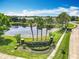 A community entrance sign next to a pond and features manicured landscaping at 16724 Cedar Crest Dr, Orlando, FL 32828