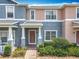 Inviting townhome entrance featuring a covered porch, brick walkway, and lush landscaping at 16724 Cedar Crest Dr, Orlando, FL 32828