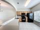 Bright kitchen features tile flooring, wood cabinets, and black appliances at 16724 Cedar Crest Dr, Orlando, FL 32828