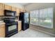 Efficient kitchen features a window for natural light and black appliances at 16724 Cedar Crest Dr, Orlando, FL 32828