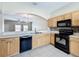 Bright kitchen featuring wood cabinets, tile backsplash, and modern black appliances at 16724 Cedar Crest Dr, Orlando, FL 32828
