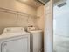Convenient laundry area features a washer, dryer, and overhead shelving for easy access and storage at 16724 Cedar Crest Dr, Orlando, FL 32828