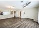 Open concept living room with hardwood floors and view of kitchen at 16724 Cedar Crest Dr, Orlando, FL 32828