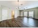 Large living room with hardwood floors and natural light; view of half bath at 16724 Cedar Crest Dr, Orlando, FL 32828