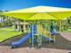 A well-maintained playground with slides and climbing area, sheltered with a sunshade at 16724 Cedar Crest Dr, Orlando, FL 32828