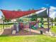 Community playground with multiple colorful play structures, slides, and shade covers at 16724 Cedar Crest Dr, Orlando, FL 32828