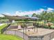 Fenced playground featuring swings and slides, with a covered seating area and landscaping at 16724 Cedar Crest Dr, Orlando, FL 32828