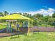 Colorful playground with slides and climbing equipment under a bright yellow sunshade at 16724 Cedar Crest Dr, Orlando, FL 32828