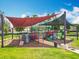 Community playground with multiple colorful play structures, slides, and shade covers at 16724 Cedar Crest Dr, Orlando, FL 32828