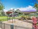 Community playground with multiple play structures, swings, slides, and shade covers for a fun outdoor experience at 16724 Cedar Crest Dr, Orlando, FL 32828