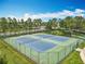 Tennis courts with newly resurfaced blue surface are surrounded by green fencing for a great sporting experience at 16724 Cedar Crest Dr, Orlando, FL 32828