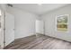 Bedroom features neutral walls, wood-look flooring, and bright windows at 16904 Sw 30Th Avenue Rd, Ocala, FL 34473