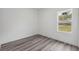 This bedroom features neutral walls, wood-look flooring, and bright windows at 16904 Sw 30Th Avenue Rd, Ocala, FL 34473