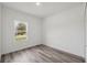 This bedroom has neutral walls, wood-look floors and a sunny window with a view at 16904 Sw 30Th Avenue Rd, Ocala, FL 34473